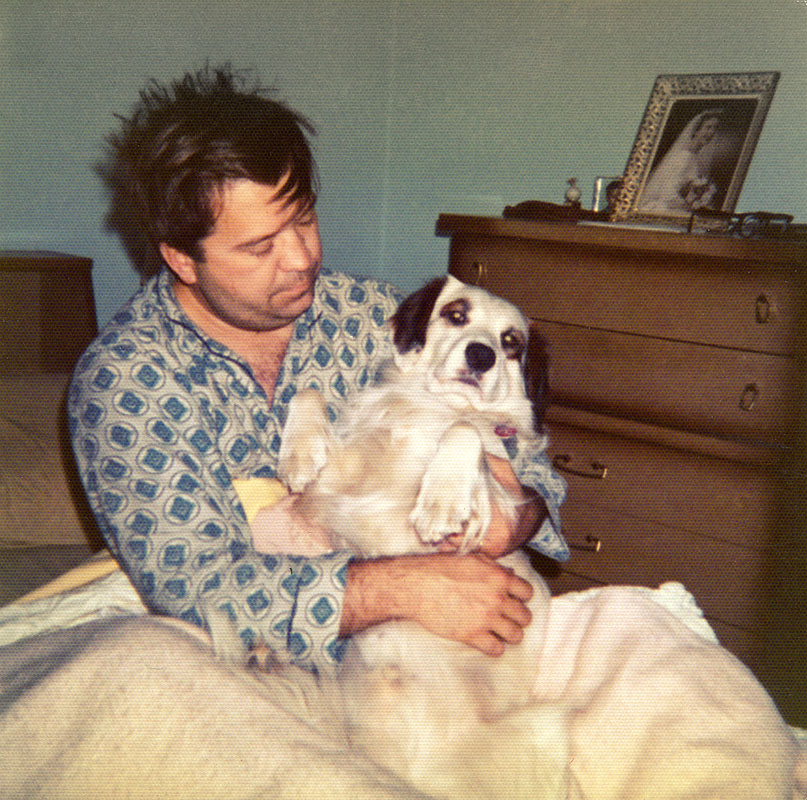 Dad holding our first dog, Snoopy